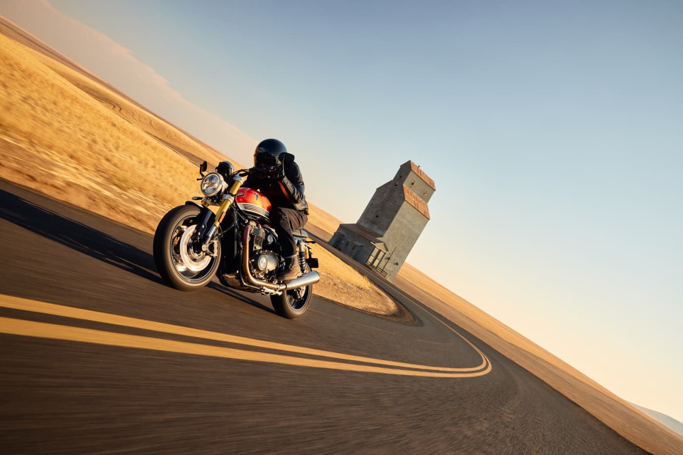 Speed Twin 1200 RS on a desert highway at golden hour